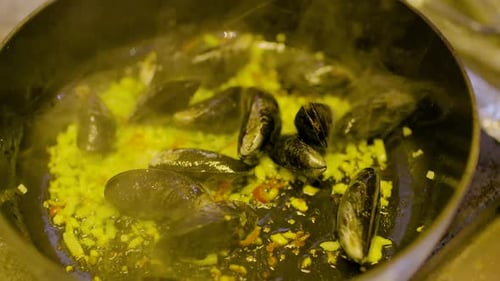 Close Up of Steaming Mussels Cooking in Skillet