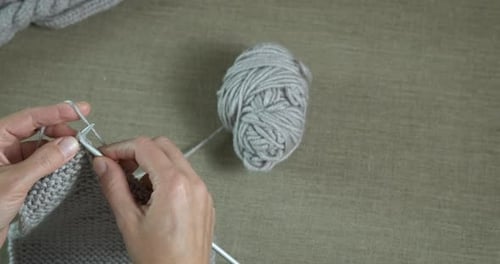 Adult Hands Knitting Gray Wool Yarn