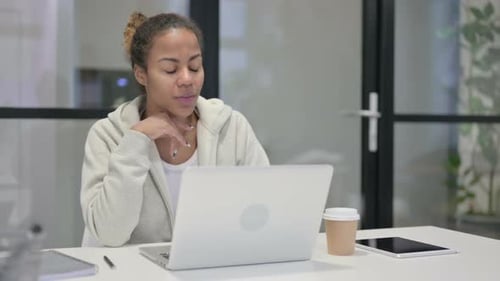 African Woman Talking on Video Call on Laptop in Office