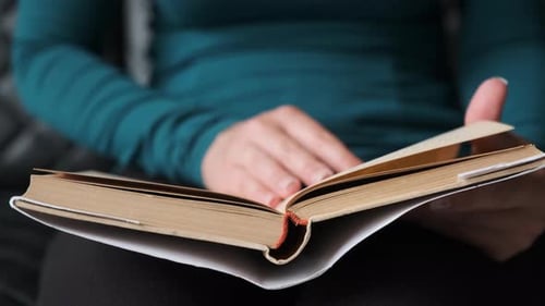 Young Girl Reading Book. Close-up Book Reading