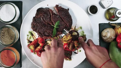 View from Above of Cutting Steak on Plate