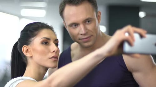Sport Couple Taking Selfie in Gym, Posting Fitness Routine in Social Network