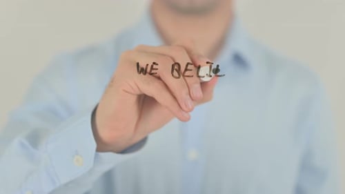 Man Writing Business Message on Transparent Surface