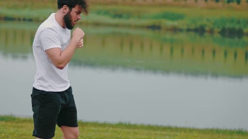 Young Adult Boxer Practices Punches Outdoors