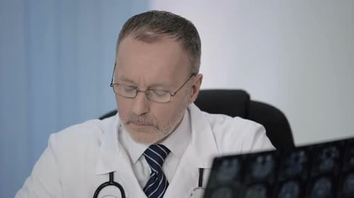 Doctor Reviews Brain Scan in Office