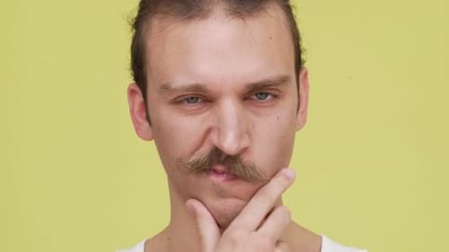 Closeup Serious Caucasian Young Man Planning Some Idea Touching Chin with Strong View