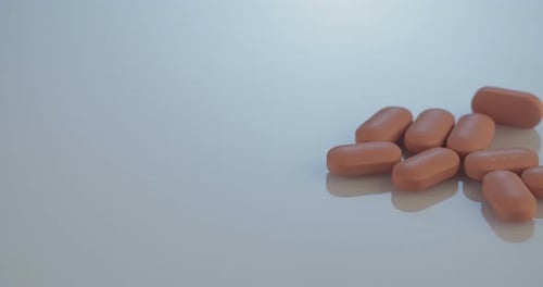 Capsule Pills on Reflective Surface in Close Up