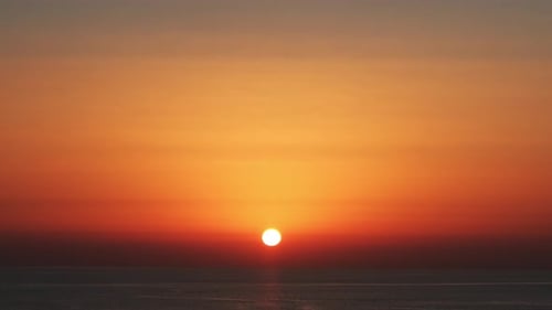 amazing cinematic orange sky timelapse of the sunset over the sea to mark the passage of time