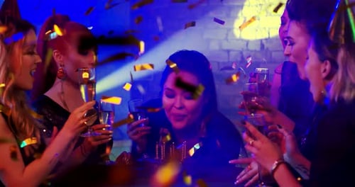 Friends Celebrate Birthday with Champagne and Confetti