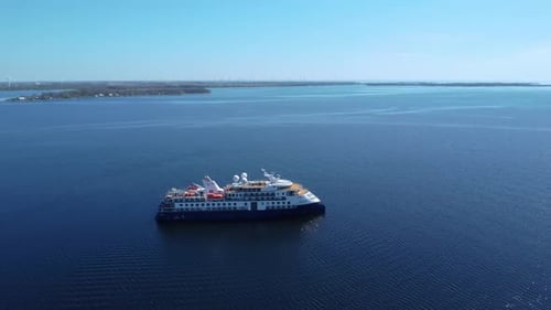 aerial view of cruise ship in open water on a blue sky day