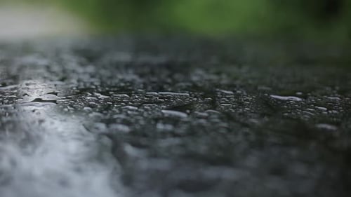 Raindrops falling on garden table