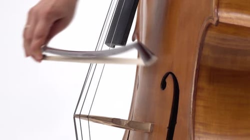 Woman Hand Playing Violoncello with Cello Bow. Close Up