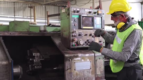 Senior Factory Worker Teach How to Use Machine Equipment in the Factory Workshop