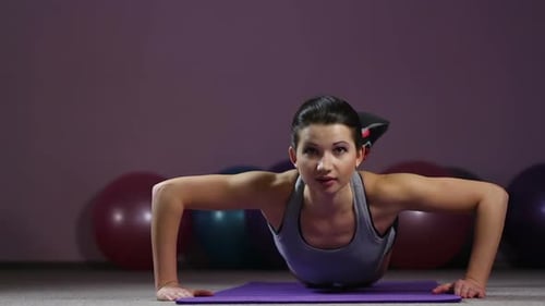 Young Woman Doing Push Ups on Yoga Mat