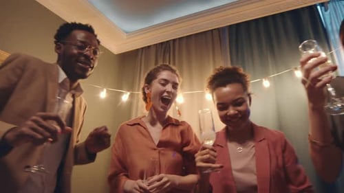 Friends and Family Dancing with Champagne at Party