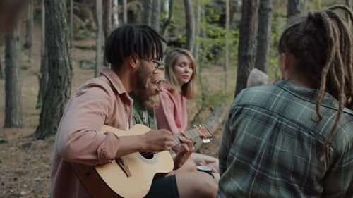 Friends Gather in Forest with Guitar Music