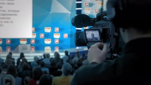 Cameraman Films a Speaker at a Corporate Conference