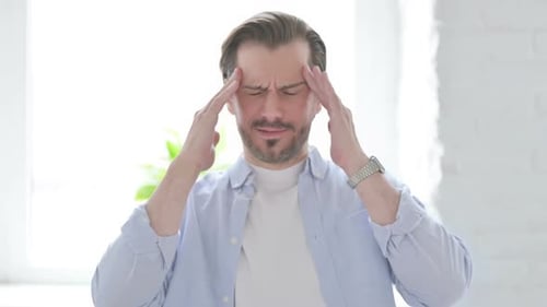 Man Massaging Temples, Suffering From Headache