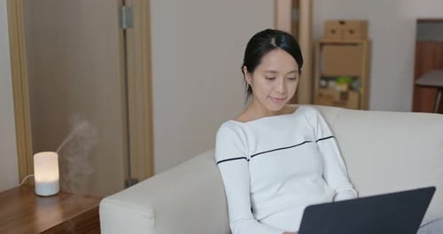 Woman type on computer at home
