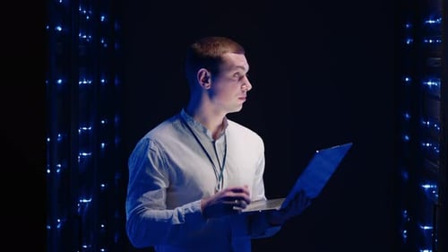 IT Technician in Data Center Digital Server Room Controlling Work of Rack Server Cabinets with a