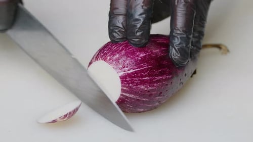 Slicing Fresh Eggplant with Knife Close Up