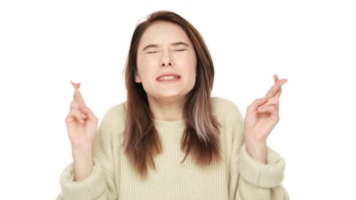 Young Woman Crossing Fingers in Hope and Anticipation