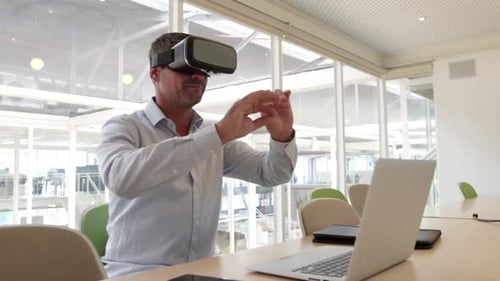 Businessman using virtual reality headset at desk in modern office 4 4k