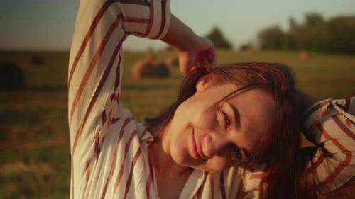 Smiling Woman Posing in Golden Field