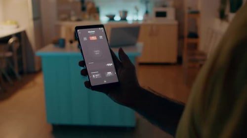 Man Controlling Smart Home with App on Phone