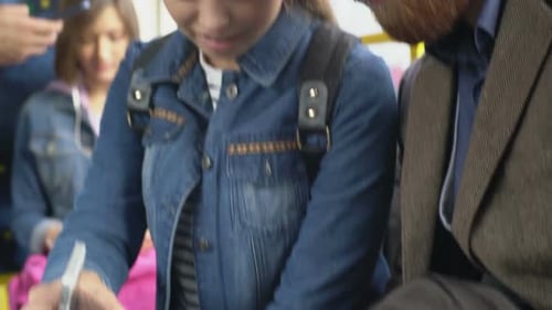 People Riding Bus Using Mobile Technology