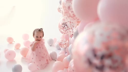 Adorable Baby Girl Surrounded by Pastel Balloons
