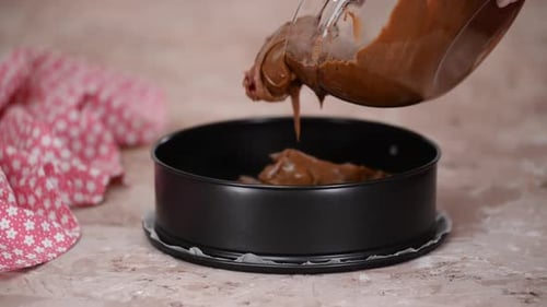 Chocolate Batter Pouring Into Cake Pan for Baking