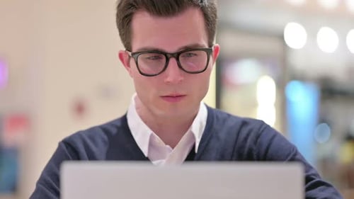 Close Up of Young Businessman Working on Laptop