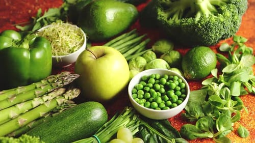 Fresh Green Vegetables and Fruits Assortment Placed on a Rusty Metal