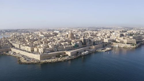 Historical coastal city Valletta,Malta,with stone harbor walls,aerial.