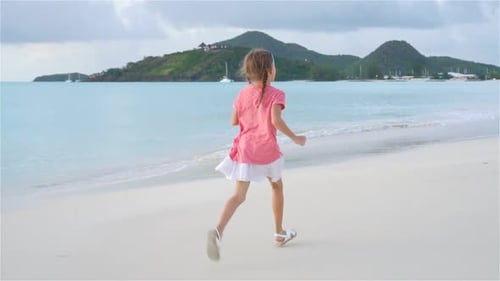 Adorable Little Girl on the Beach Having Fun on Caribbean Island. SLOW MOTION