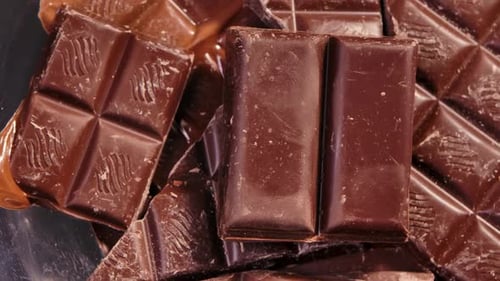 Chocolate Chunks of Sweet Chocolate Rotated Close Up