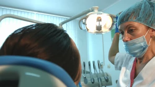 Dentist Treating Patient in Dental Clinic Setting
