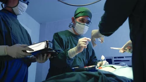 Surgeons Performing Operation in Hospital Operating Room