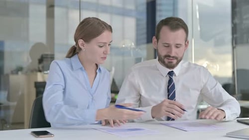 Business People Having Arguments on Documents in Office
