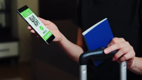 Traveler Holding Passport and COVID Vaccination Health Pass