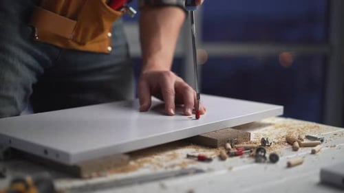 Man Assembling Furniture at Home with Hand Tools