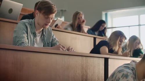 The Camera Moves Through the Audience Where the Students Write a Lecture on Laptops and Notebooks