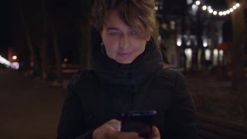 Beautiful Caucasian Woman in Using Smartphone or Cell Phone on the Street