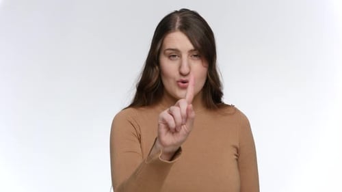 Studio Portrait of Young Woman Shaking Her Figner and Saying No