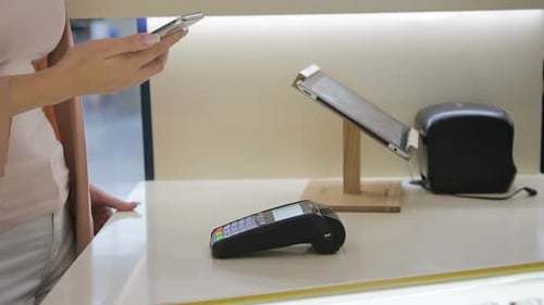 Woman Makes Contactless Payment with Smartphone