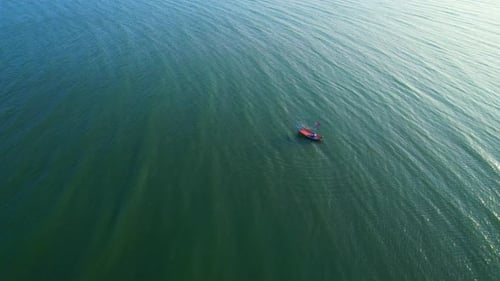 Aerial drone view of a fisherman boat in the sea near the coast.