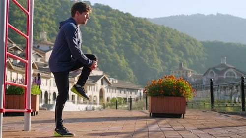 Man Stretching Legs in Urban Outdoor Setting