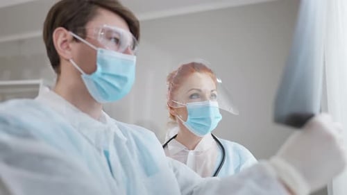 Medical Staff Examining X-Ray in Hospital