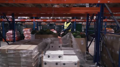 Workers Moves on a Forklift in a Warehouse